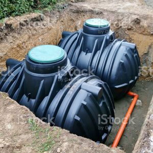 Two plastic underground storage tanks placed below ground for harvesting a rainwater.