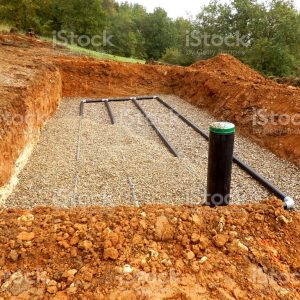 Bottom layer of pipework laid on gravel in the construction of a sand and gravel drainage system